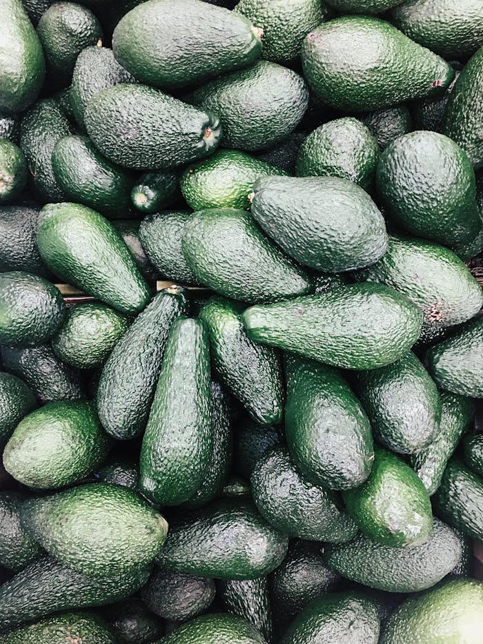 A pile of fresh Hass avocados, perfect for healthy eating and keto diets. Vibrant and nutritious.