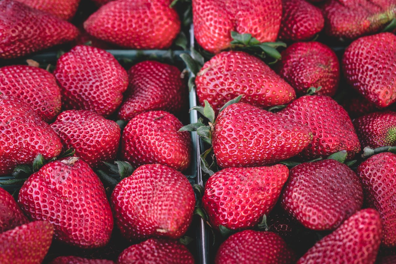 Close-up of fresh, ripe strawberries showcasing their vibrant red color and texture.